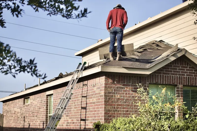 Professional roofer working on a residential roof in West Jupiter Camping Resort
